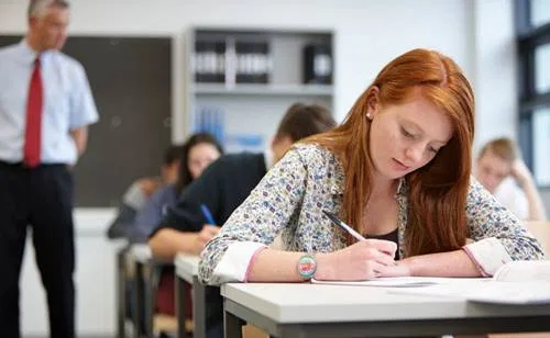 teacher-watching-over-teenagers-in-classroom-2023-11-27-05-26-29-utc.jpg